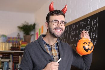 Student holding pumpkin before Halloween