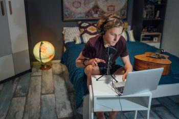 Students playing the guitar and searching the web